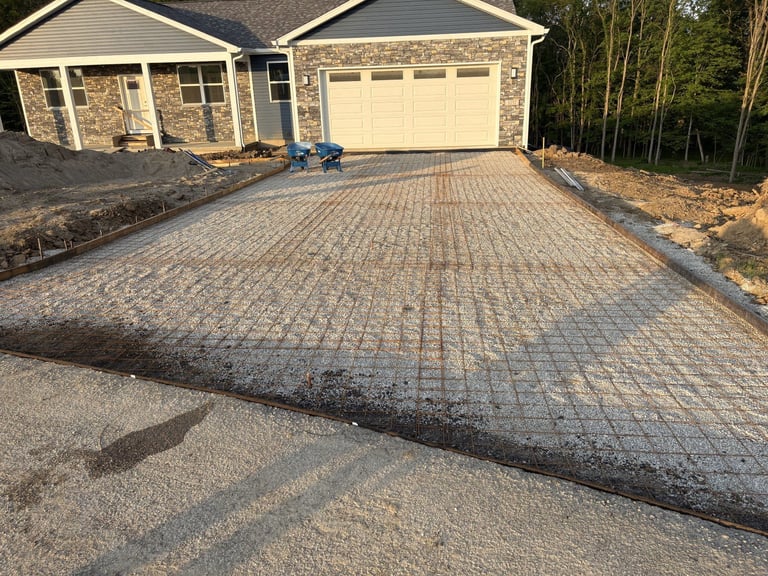 Newly installed brick paver driveway in front of a two-car garage home with landscaping