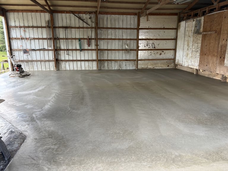 Empty garage interior with concrete floor and metal-framed garage doors
